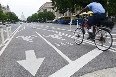 Bicyclist rides in a protected bike lane in Washington, D.C. Photo: iStock.