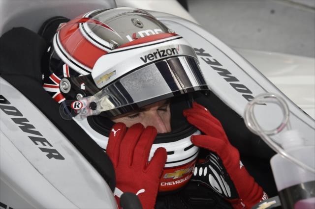 Will Power adjust his helmet with Racing Optics' tear-offs on visors