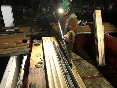 Driller Riley Bowers empties an Aziwell tube of BQ drill core for MB-21-216w1 (CNW Group/Foran Mining Corporation)