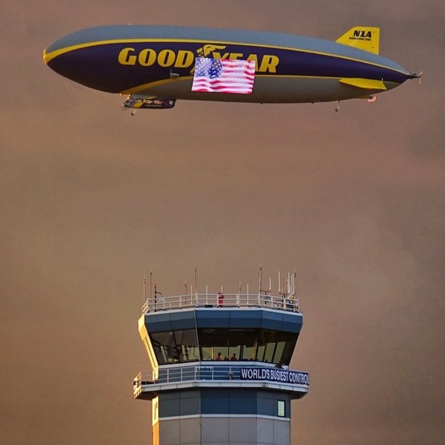 The Goodyear Blimp flies over EAA AirVenture Oshkosh's Air Traffic Control Tower.