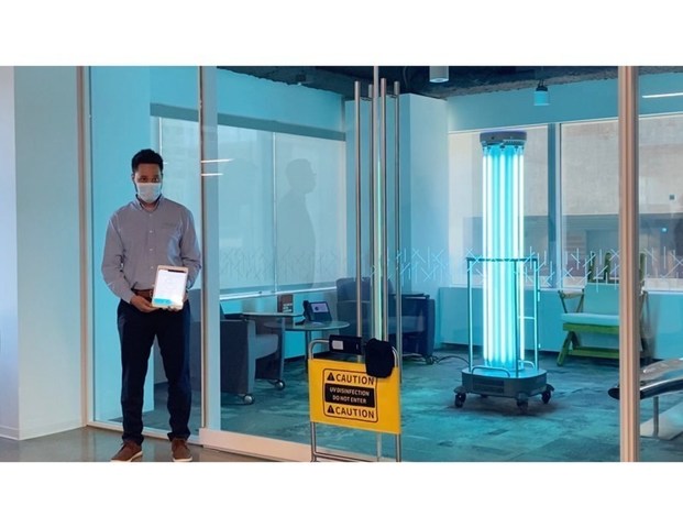 UBTECH technician uses app to prompt robot to disinfect air and surfaces of office space at Coretrust Capital Partners' property.