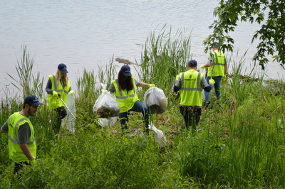 The Pure Planet Day team collects plastic waste along the Ohio river bank and County Road 1A in Ironton near PureCycle's recycling facilities.