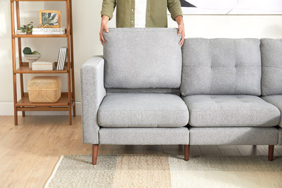 Customers can change up the look of their living room in an instant with the Endy Sofa's reversible pillows, featuring a tufted and non-tufted side. The sofa's grey, linen-look fabric and solid wood legs in a walnut finish add elevated flair. (CNW Group/Endy)