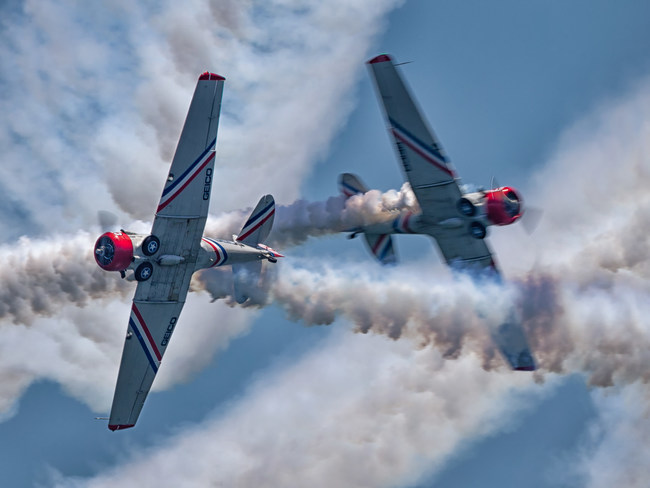 The solo aircraft from the GEICO Skytypers Air Show Team in a close head-on pass.