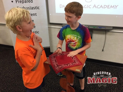 Discover Magic students practice with each other and learn at least one new trick per class.