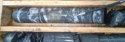 Core photo 1: Massive sulfide within DH-128: 0.3 metres @ 5.7 g Au/t and 5,621 g Ag/t. (CNW Group/Outcrop Gold Corp.)