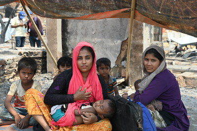 Anwara, 27, huddles with her children in a makeshift shelter in the Rohingya refugee camp in Bangladesh. Bangladesh has postponed Covid-19 vaccinations for nearly one million Rohingya refugees living in the world's largest refugee camp, the only group in the country that has not yet had access to the vaccine. (CNW Group/World Vision Canada)