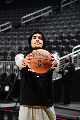 Wilson Advisory Staff member and Atlanta Hawks point guard, Trae Young, holds the new official game ball of the NBA.