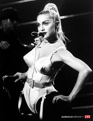 Singer Madonna wearing a pointed-bust corset by fashion designer Jean-Paul Gaultier while performing during her "Blonde Ambition" concert at Nassau Coliseum in 1990. Photo credit: DMI/The LIFE Picture Collection/Shutterstock.