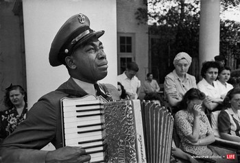 FDR'S WARM SPRINGS FUNERAL - Navy CPO Graham Jackson with tears of grief streaming down his cheeks as he plays 'Goin' Home' on the accordion, while President Franklin D. Roosevelt's body is carried from the Warm Springs Foundation where he died suddenly on April 12, 1945 of a stroke. Photo credit: Ed Clark/The LIFE Picture Collection/Shutterstock.