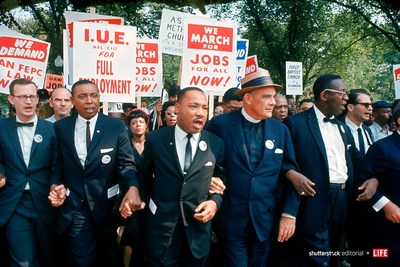 Leaders of March on Washington for Jobs & Freedom marching with signs in 1963 (R-L): Matthew Ahmann, Floyd McKissick, Martin Luther King Jr., Rev. Eugene Carson Blake and unident. Photo credit: Robert W. Kelley/The LIFE Picture Collection/Shutterstock.