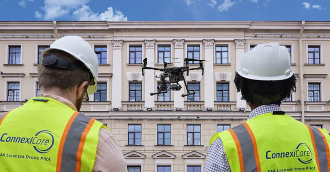 Drone pilots inspecting a building façade