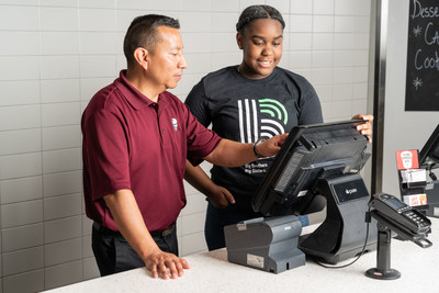 Xavier Echeverria, Managing Partner at KFC in Overland Park, KS, shows Trionni how KFC processes customers’ orders. KFC’s donation to Big Brothers Big Sisters of America will allow the organization to provide Littles with the opportunity to learn about career paths in the restaurant industry.
