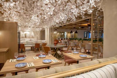 Serena Pastificio's dining room, featuring warm wood accents + a stunning hanging art installation
