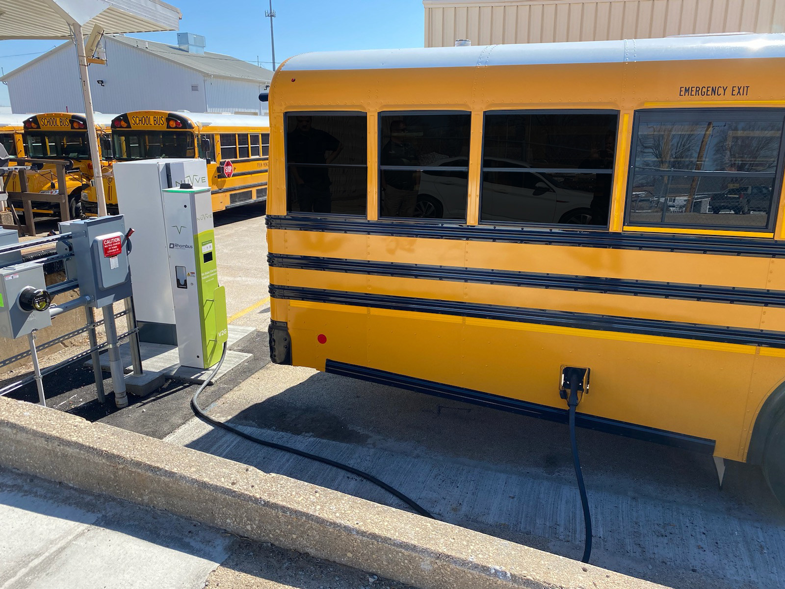 Nuvve DC V2G Charging Station from Rhombus Energy Solutions charging a Blue Bird school bus.