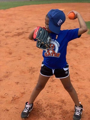 A grant from the Perfect Game Cares Foundation's Grow the Game Fund is providing baseball and softball playing opportunities for Atlanta-area students, including this young girl from Slater Elementary School.
