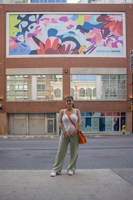 Raquel Da Silva, OCAD University Faculty of Design student, in front of her pieces at the CF Toronto Eaton Centre Art Corridor. (CNW Group/Cadillac Fairview Corporation Limited)