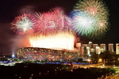 Photo shows fireworks explode over the National Stadium. (Photo by Xinhua News Agency)