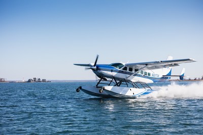 Cessna Grand Caravan amphibian mid-take off from water runway.