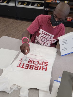 United Ability JETS Student, Corey R. working at Hibbett labeling bags. Photo Credit: United Ability