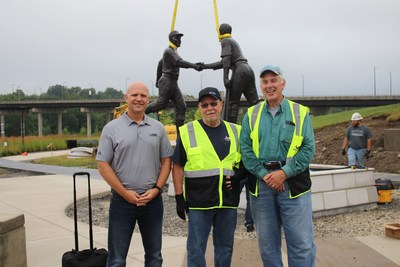 Aim Co-President Scott Fleming (left) and employees Cliff Dilling and Bob Thibodeau watched the placement of the Robinson-Shuba statue after Bob, Cliff and an Aim colleague, Scott Harris (not pictured), delivered the statue safely from the casting foundry in Brooklyn, N.Y.