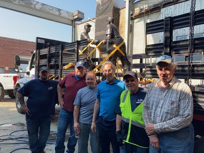 The Aim driving team secures the statue in Brooklyn, NY, with the help of members of the Robinson-Shuba 