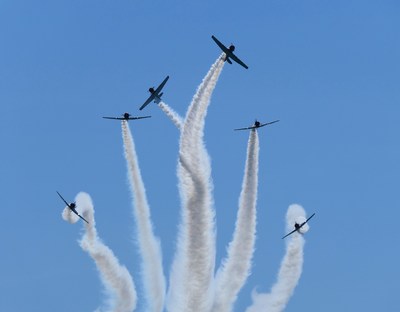 The GEICO Skytypers Air Show Team performs an "Implosion". This is one of twenty formations or maneuvers performs during their 18-minute low-level precision-flying demonstration.