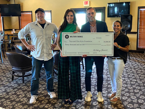 Taya Kyle Accepting the donation from Brad Dahl and Shawn Burst with Military.Finance