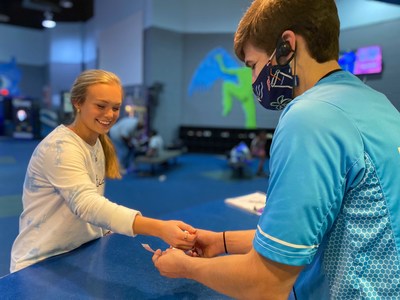 A Flight Crew Team Member checks in a Guest and welcomes them back into the park!