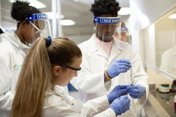FMI students, Melly Young Jr., Dasha Hammond and Mentor, Savannah Baker performing an extraction in drug chemistry.
