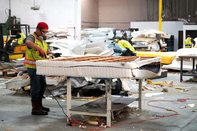 The first step in the mattress recycling process is to cut the mattress open and separate the layers of materials.