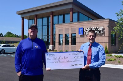 Landmark Credit Union branch manager, Ryan Hesprich (right), presents Tom "Mel" Stanton (left), executive director of Mel's Charities, with a $1,000 donation to celebrate the opening of the credit union's new Mequon, Wis. branch.