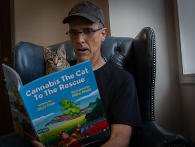 Author Jerry Frye pictured reading to his cat Cannabis