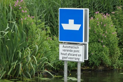 Dutch autonomous robotaxi ferry navigation sign.