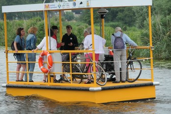 Autonomous robotaxi solar electric commercial ferry service boat carrying bicyclists.