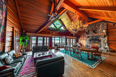 The upper level of the boathouse features volume ceilings with handsome woodwork, a hand-laid stone fireplace, and waterfront balcony offering beautiful lake views. The location is an excellent venue for observing the annual summer regattas of the St. Regis Yacht Club, one of the oldest inland yacht clubs in America. NewYorkLuxuryAuction.com