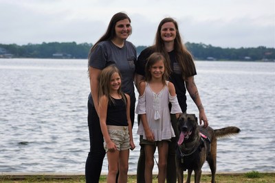 SSgt Allio Easom (right) with MWD Luna, her wife and two kids.