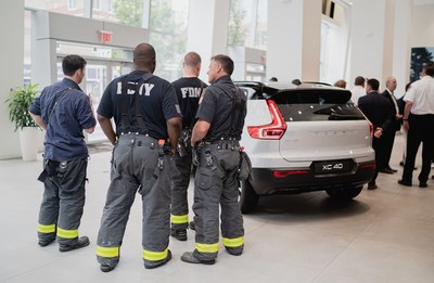 Fire fighters with the donated all-electric XC40 Recharge at Manhattan Volvo located at 565 11th Avenue in New York City.