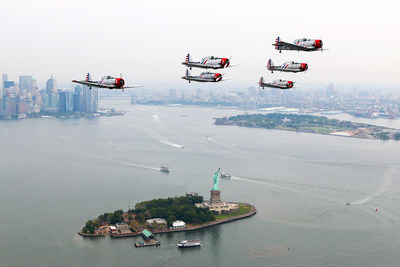 The GEICO Skytypers Air Show Team flies in a delta formation over the Statue of Liberty.
