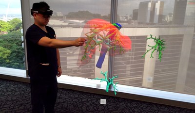 With the help of a Mixed Reality headset, a three-dimensional hologram of a patient’s liver scan is projected into space, allowing Dr Gao Yujia, Associate Consultant with the Division of Hepatobiliary & Pancreatic Surgery, National University Hospital, and the programme lead for the holomedicine programme at the National University Health System to control and view the holographic image from different angles.