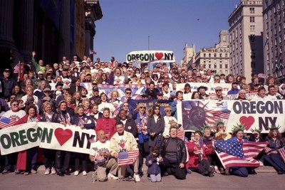 Oregonians on the Flight for Freedom sing "God Bless America" after marching in New York's 2001 Columbus Day Parade, October 8, 2001. Standing in the red jacket at center, Portland Mayor Vera Katz. Kneeling in front of her are organizers Sho Dozono, Portland Chamber of Commerce chair, and Jack McGowan, SOLV executive director. Photo courtesy of Loen Dozono.
