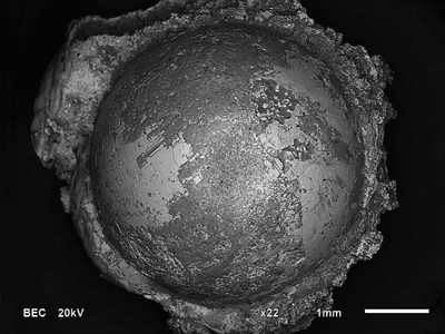 Button-shaped iron silicide spherule