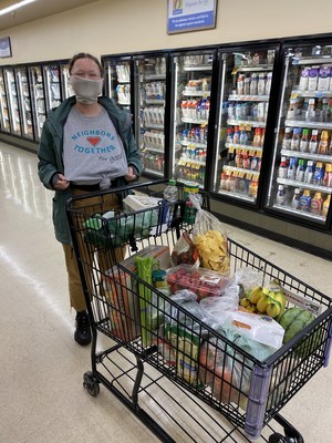 A volunteer with Neighbors Together for Good, grocery shopping and preparing for emergency food delivery to isolated community members during the COVID-19 pandemic.
