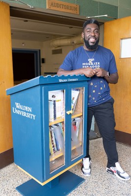 Walden University's Center for Social Change Director, Isaac Cudjoe, stands next to a Walden Community Library in Baltimore, Maryland.