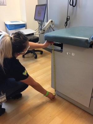 An IEHP Team Member measures a local Provider's exam table in an accessibility assessment. To further support health equity and the need for accessible, comprehensive exams for residents with disabilities, IEHP also plans to provide comprehensive feedback based on each provider's PARS response and conduct Culture Competency Trainings for providers who receive accessible exam tables.