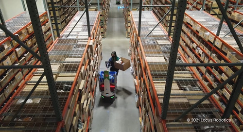 A LocusBot assisting one of evo's warehouse workers.
