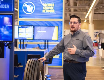 Austin Crayne, Goodyear’s business development manager, demonstrates the Goodyear CheckPoint drive-over-reader device – now available in customizable leasing options for North American fleets – which provides automated tire inspections for pressure and tread depth. (Jessica Yanesh for Goodyear)