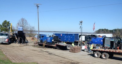 Contractors use equipment to bore underneath a body of water to complete a C Spire long haul fiber route. The company recently completed a 225-mile fiber route from Kiln, Mississippi to West Mobile, Alabama, overcoming weather delays, permitting requirements and sensitive environmental issues.