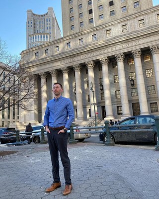 R.T. Custer, co-founder of Vortic Watch Company, stands victorious in front of the Federal Courthouse in New York City.