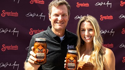 Dale Jr. and Amy Earnhardt hold bottles of Sugarlands Electric Orange Sippin' Cream, which is being rechristened Dale and Amy's Electric Orange Sippin' Cream. The Earnhardts and Sugarlands announced a strategic partnership that includes existing and new Sugarlands products to bear the Earnhardt's names Saturday,  September 18, 2021, before the NASCAR Playoffs race at Bristol Motor Speedway.